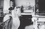 Technicians examining slides 1910 by Baystate Health Sciences Library